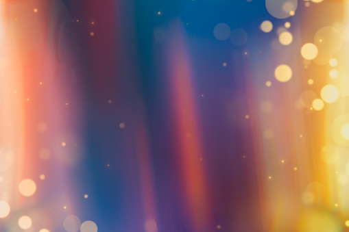 abstract rainbow gradient background with golden defocused lights and space for text