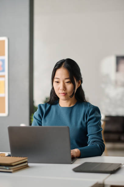 istock Asian Female Manager Texting On Laptop 2131994530