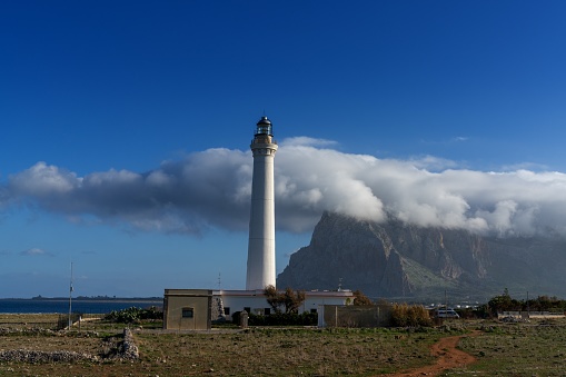 San Vito lo Capo, Italy - 4 Janaury, 2024: view of the Capo San Vito lighthouse with Monte Monaco behind in northwestern Sicily