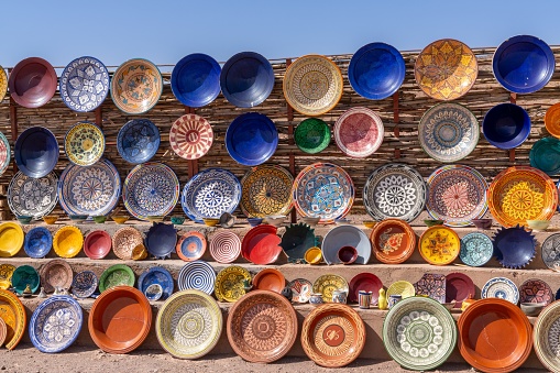 Many colorful bowls and platters on display in a traditional Moroccan arts and crafts shop