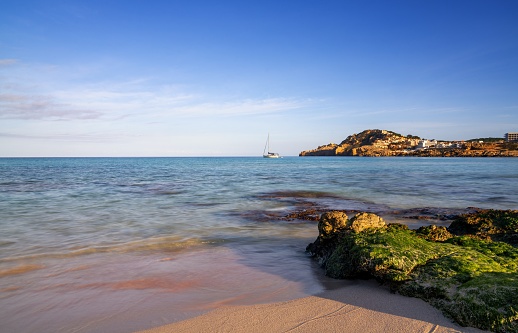 Ferragudo, Lagoa, Algarve / Faro District, Portugal: a gentle wave on the Caneiros Beach - in the background the Altar Headland and the Gaivotas Islet - Praia dos Caneiros, Ponta do Altar e Leixão das Gaivotas.