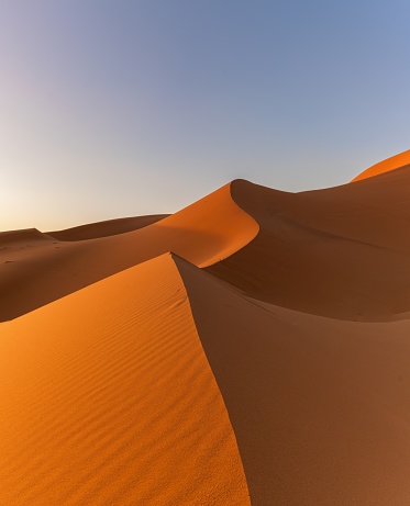 vertical view of the sand dunes at Erg Chebbi in Morocco in warm evening light