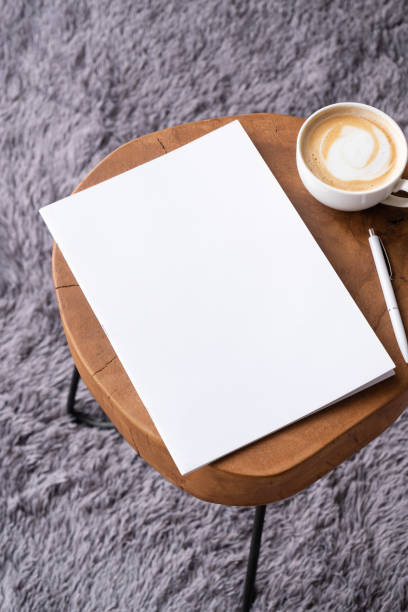istock blank magazine mockup on coffee table with cappuccino, pen and grey rug 2132070154