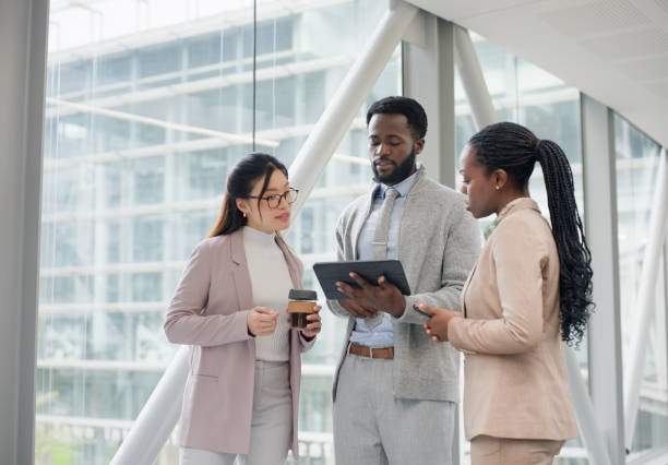 istock Business people, tablet and conversation with group, planning and trading info with digital app. Staff, finance or accountant with tech or teamwork with cooperation or online reading for stock market 2132074225