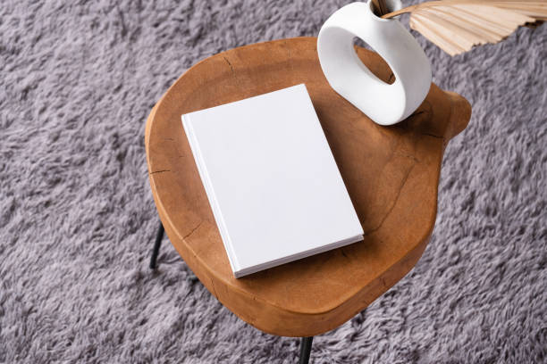 istock blank book mockup on coffee table with decorations and grey rug 2132100442