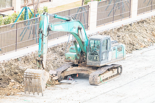On a sunny day on February 19, 2024, an excavator was working on a road in Shuangliu District, Chengdu City, Sichuan Province