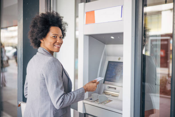 istock African woman using credit card on Cash machine. 2132129735