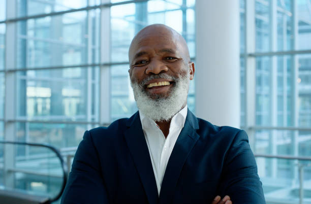 istock Mature man, portrait and smile with office, confidence and work for professional startup financial advisor. Employee, consultant and entrepreneur with corporate, workspace and happiness at law firm 2132136704