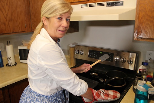 older housewife in her kitchen baking, cooking