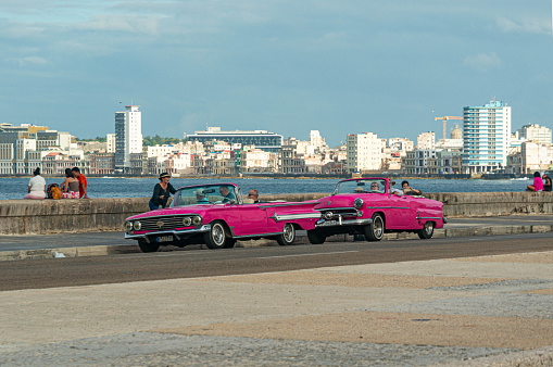 Pink retro convertibles on the Malecon Promenade in Havana, the capital of Cuba