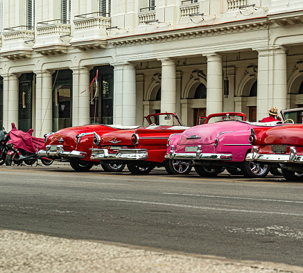 Bright retro cars on Havana street near the hotel.