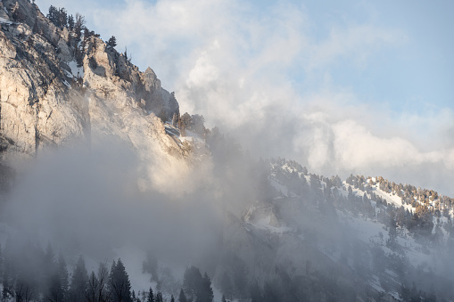 The mountains of Little Cottonwood Canyon in Utah at sunset with snow