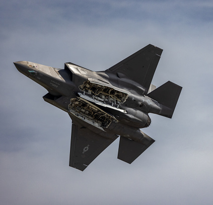 A United States Air Force F-35 performing during a demonstration at an airshow with its bomb bay open