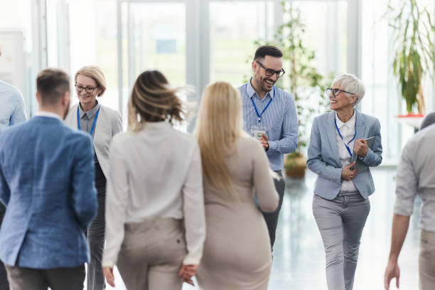 istock Large group of happy entrepreneurs walking in a hallway. 2132154595