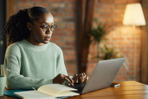 istock Black creative woman working on laptop at home office. 2132179099