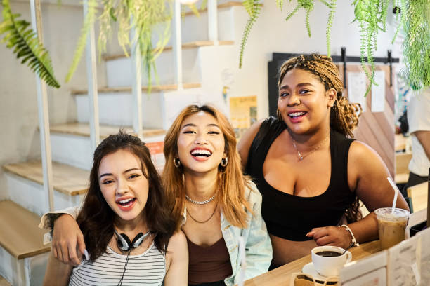 istock Multiracial happy girls having fun together in a cafe 2132179103