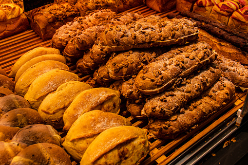 A closeup shot of a bakery shelf full of assorted pastries and treats