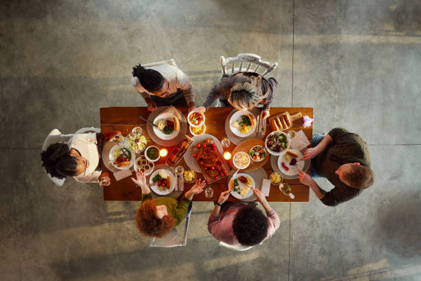 istock Above view of young friends having lunch at dining table. 2132183363