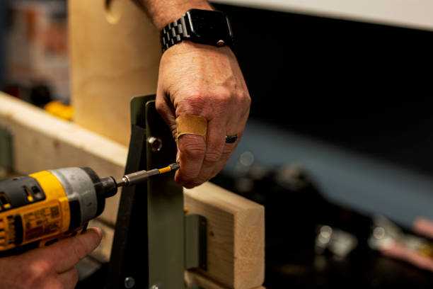 istock a man works with wood panels and tools in his workshop. real life. rough hands, finger covered with adhesive tape. 2132194410