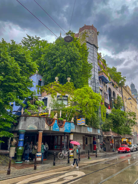 Hundertwasser house in Vienna, Austria during a rainy day in spring Hundertwasser house in Vienna, Austria during a rainy day in spring with tourists walking the streets. hundertwasser house stock pictures, royalty-free photos & images