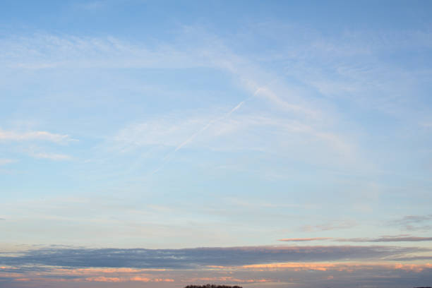 Beautiful Spring Sky at sunset in Mecklenburg-Vorpommern, some treetops at the bottom edge visible