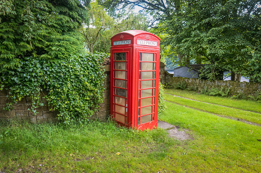 07.04.203 Ladybower, Derbyshiire, UK. The red telephone box, a telephone kiosk for a public telephone designed by Sir Giles Gilbert Scott, is a familiar sight on the streets of the United Kingdom,