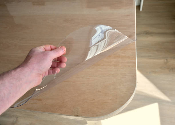 istock Protective tablecloth in transparent plastic, on a plywood kitchen table. 2132231191