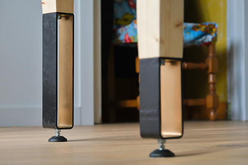 Table legs in bent steel and wood, painted bronze and black.
