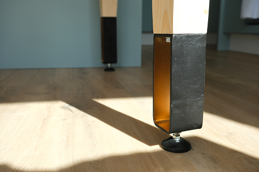 Table legs in bent steel and wood, painted bronze and black.