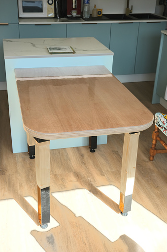 DIY wooden table with plywood top, wood and steel legs.