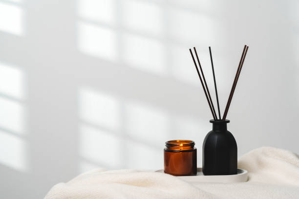 istock Elegant Aroma Diffuser With Reed Sticks And Scented Candle On White Tablecloth 2132247060