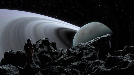 Cosmonaut space explorer stands on a moons rugged terrain, mesmerized by a massive ringed planet in the cosmos. 3d render
