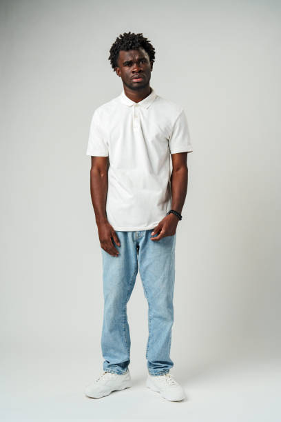 istock Young African American Man in White Shirt Expressing Confusion in Studio 2132282405