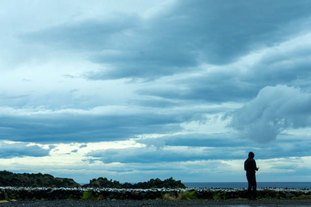 Solitary man in hooded cloak.