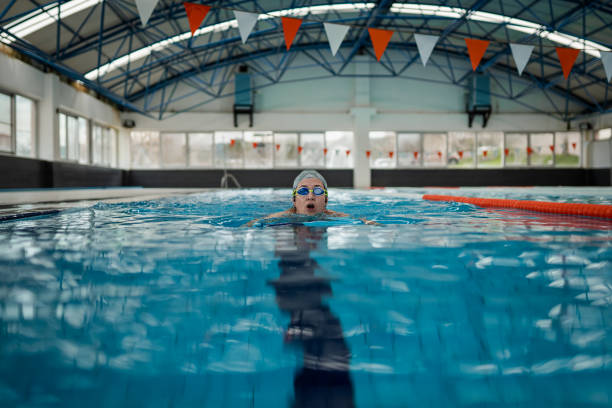 istock Female Athlete swim butterfly at pool 2132361197