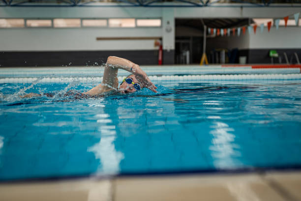Female Athlete swim freestyle at pool