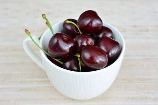 a white mug with dark garden cherries isolated