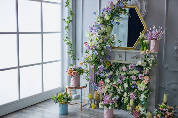 Mirror on a white wall, decorated with flower garlands.