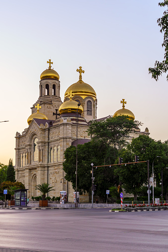 Varna, Bulgaria - September 22, 2023: Sunset view of the Dormition of the Theotokos Cathedral, with locals and visitors, Varna, Bulgaria