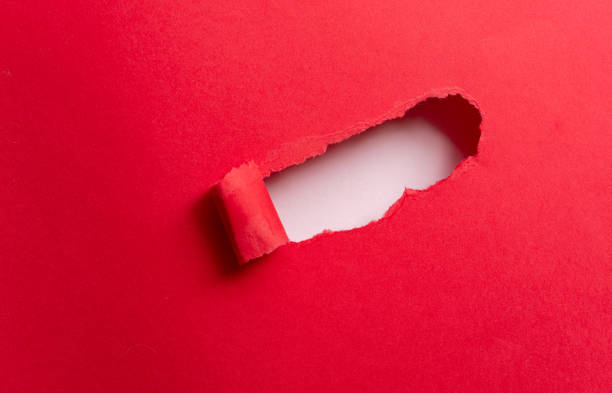 istock red paper with holes 2132378370