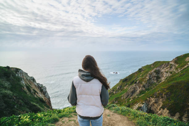 istock Woman looking at the ocean view from a cliff 2132380949