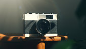 Vintage analog 35mm film camera in moody light