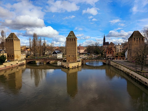 The Ponts Couverts are a set of three bridges and four towers that make up a defensive work erected in the 13th century on the River Ill in the city of Strasbourg. The image was captured during spring season.