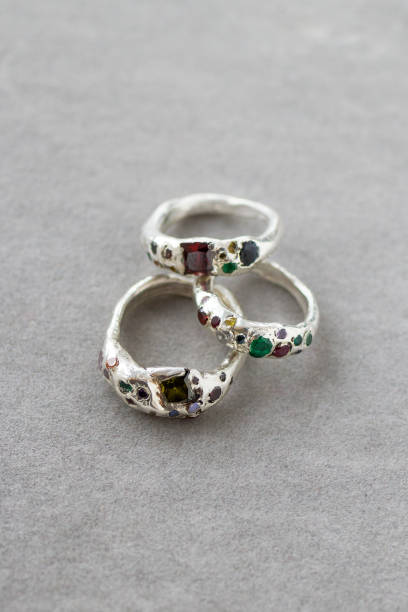 istock Three silver rings with natural gemstones on a gray background, highlighting their beauty. Elegant and sophisticated, perfect for special occasions. 2132401538