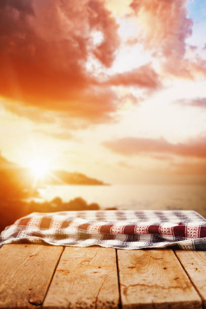 istock Empty wooden picnic table at sunset by the sea 2132412994