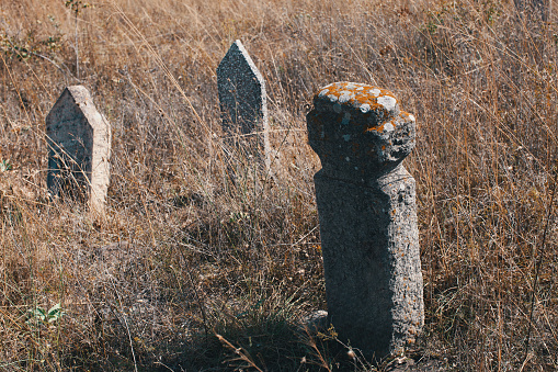 Tombstones with unreadable text on it. Image captured in a Turkish-Muslim village graveyard in southern Bulgaria