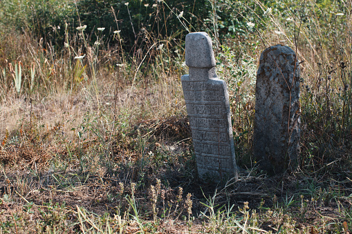 Tombstones with unreadable text on it. Image captured in a Turkish-Muslim village graveyard in southern Bulgaria