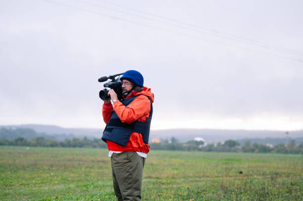 istock Reporter in bulletproof vest holding a video camera 2132421222