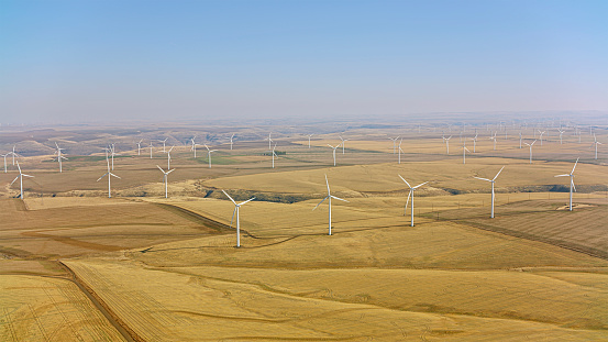 Aerial view of vast wind turbine on windmill farm in  on sunny day in Washington, USA.