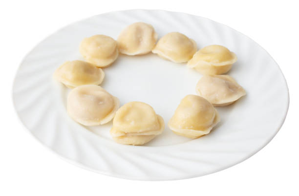 Boiled dumplings in a plate isolated on a white background. View from above.